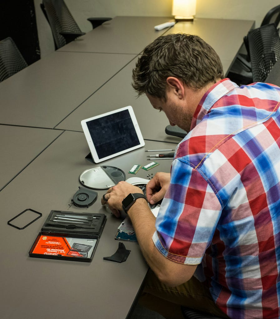 Focused technician repairing computer in workshop