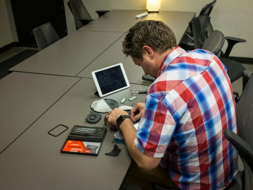 Focused technician repairing computer in workshop